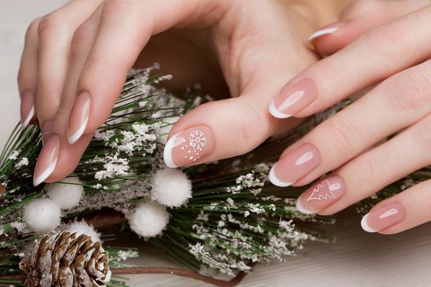 Snow White manicure on female hands. Winter nail design. Picture taken in the studio on a background of wool