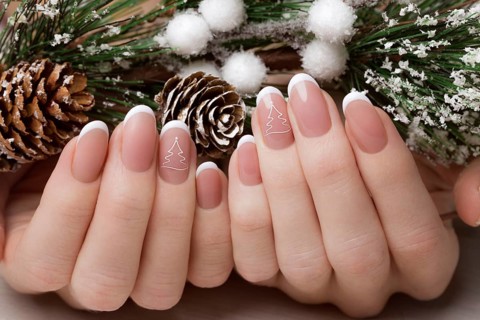 Snow White manicure on female hands. Winter nail design. Picture taken in the studio on a background of wool