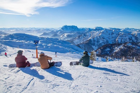 Snowboarders resting at the summit