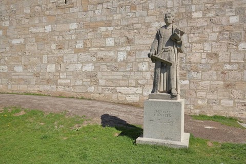 Monument and statue by Thomas Muenzter with book