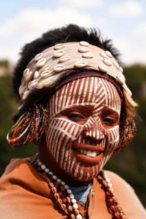 Kikuyu woman with face paint poses for photographers at Nyahururu Falls