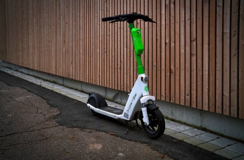 E-scooter parked on the side of the road in the bike rental of the company Lime
