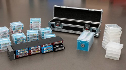 Data backup magnetic tapes lie next to a lockable transport case