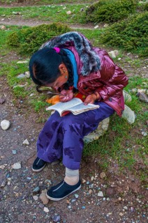 Student writing with a peasant feather