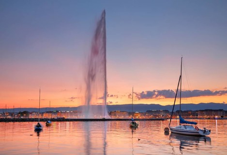 The Jet d'eau at dusk is the landmark in Geneva's harbour basin