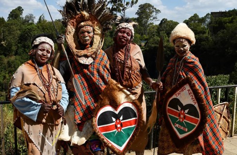 Kikuyu dancer with face paint poses for photographers at Nyahururu Falls