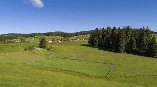 Aerial view of a football field in the Allgaeu region with a stream as a sideline