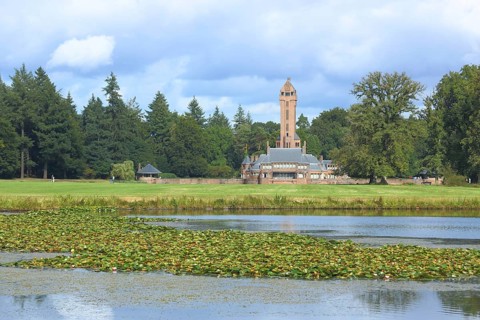 View of Jachthuis Sint Hubertus built 1915 on the lake with pond roses
