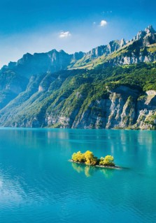 Aerial view of Lake Walen with a view of Chive Island in the turquoise water and Leistchamm and Churfirsten in the background