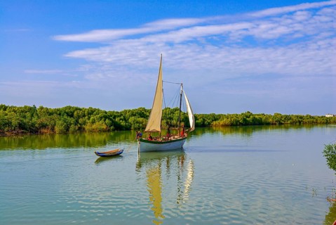 Little sailing boat shipping on a side arm