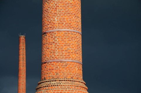 Factory chimney in front of storm clouds