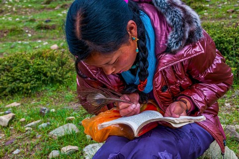Student writing with a peasant feather
