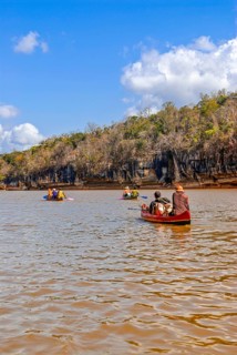 Tourists sitting in boats on the Tsiribina river