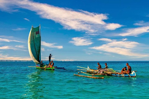 Traditional sailing boat and rowing boat with a dead