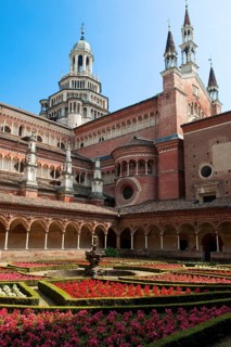 Inner courtyard decorated with planted flowers behind cloister