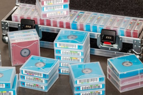 Data backup magnetic tapes lie next to a lockable transport case
