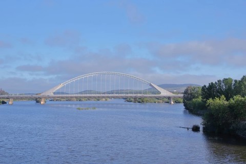 Modern arch bridge Puente Lusitanos built in 1992 over the river Rio Guadiana