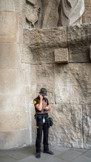 Uniformed police officer talking on his duty mobile phone