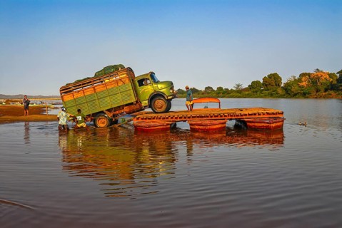 Truck crossing on a improvised ferry the Manambolo river