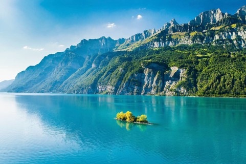 Aerial view of Lake Walen with a view of Chive Island in the turquoise water and Leistchamm and Churfirsten in the background