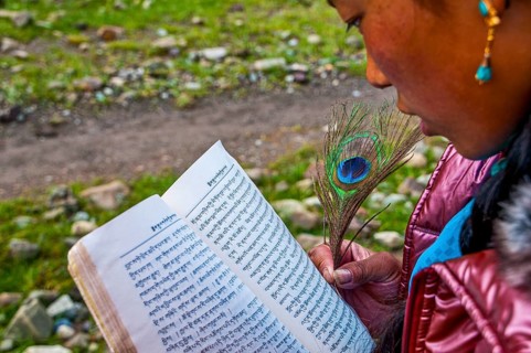 Student writing with a peasant feather