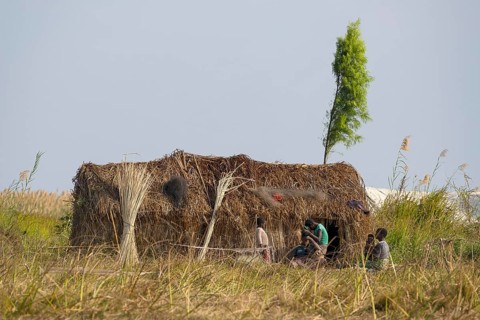 Local people with reed house