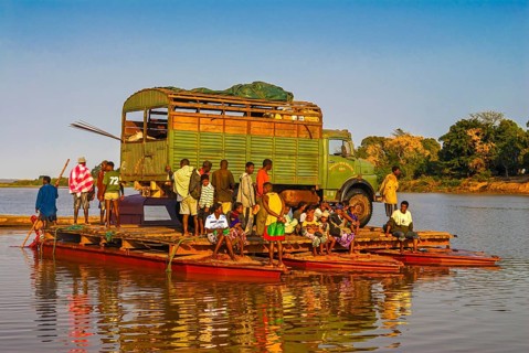 Truck crossing on a improvised ferry the Manambolo river