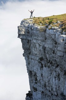 Man standing on the edge of the Creux du Van