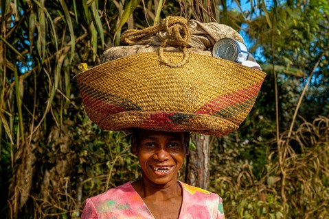 Woman carrying a bag on her head