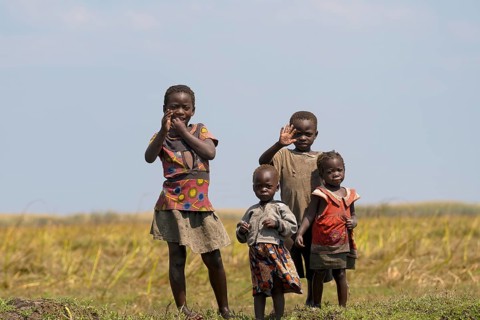 Children wave to tourists