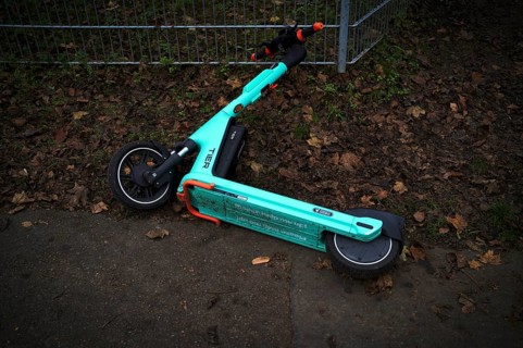 E-scooter lying on the side of the road in the bike rental of the company TIER