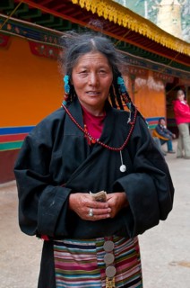 Old tibetan pilgrim in the Drepung temple