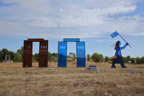 Sculpture with inscription We are the people and blue Indian