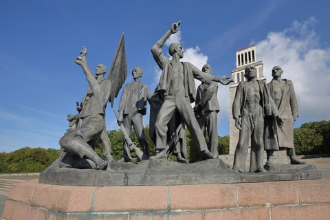 Group of figures by Fritz Cremer with bell tower