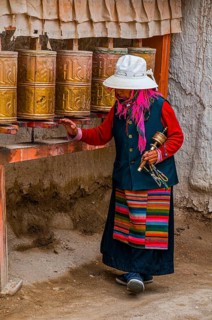 Old woman turning the prayer wheels in the kingdom of Guge