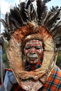 Kikuyu warrior with face paint poses for photographers at Nyahururu Falls