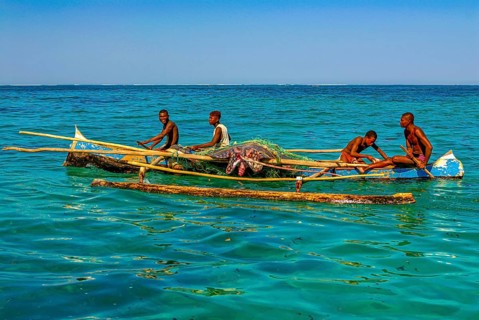 Traditional sailing boat and rowing boat with a dead
