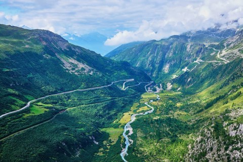 View from the Rhone glacier of the glacial stream and the pass roads