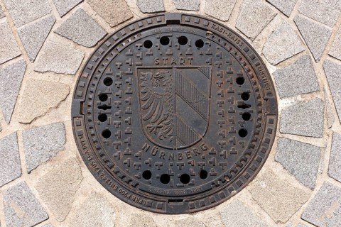 Manhole cover with the Nuremberg city coat of arms