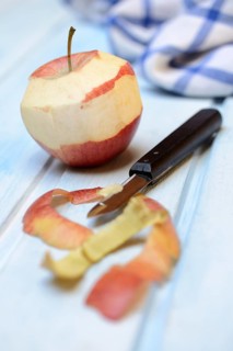 Peeled apple with peeling knife