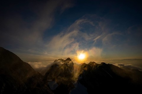 Altmann summit with yellow cloud wisps at sunrise