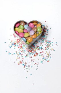 Chocolate lentils and love beads in heart-shaped cookie cutter