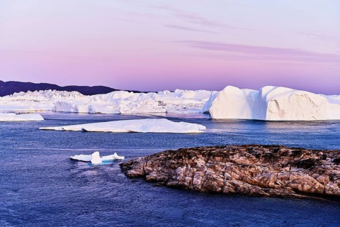 Gigantic icebergs in the light of the blue hour