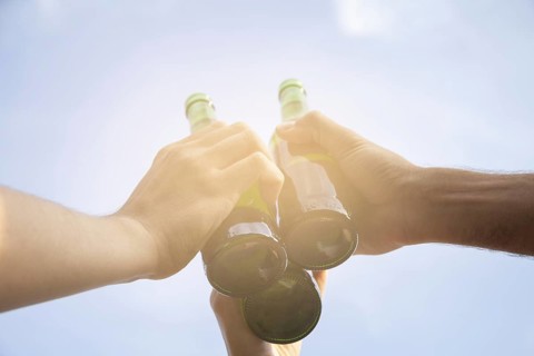 Toasting with beer bottles