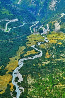 View from the Rhone glacier of the glacial stream and the pass roads