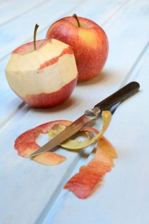 Peeled apple with peeling knife