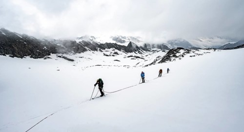 Ski tourers ascending the rope
