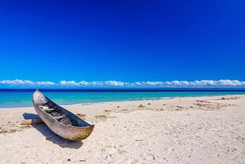 Canoe on a white sand beach on the Island Ile Sainte-Marie although Nosy Boraha