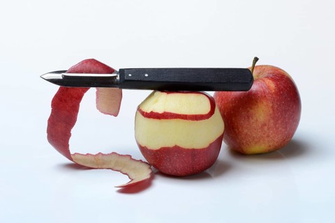 Peeled apple with peeling knife