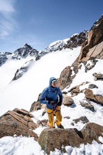 Ski tourers preparing rope belay for descent on the rope
